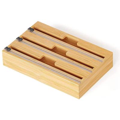 China Viable 3 in 1 Compatible Bamboo Roll Holder Wrap Dispenser Organizer with Cutter and Logo for Kitchen Drawer for sale