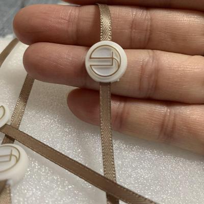 China Sustainable Custom Luxury Hanging Plastic Label Design Apparel Garment Tag Seal String Hanger Tag For Apparel Garment for sale