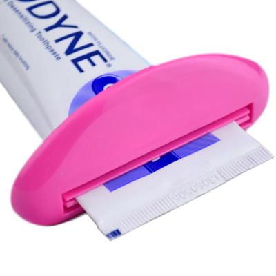 China Viable Good Selling Gifts Plastic Toothpaste Tube Squeezer Roll Dispenser Holder Stand Clip for sale