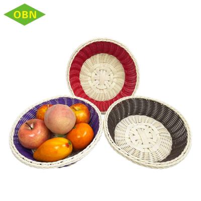 China Kitchen Sustainable Colorful Washable Round PP Handmade Woven Rattan Plastic Fruit Basket for sale