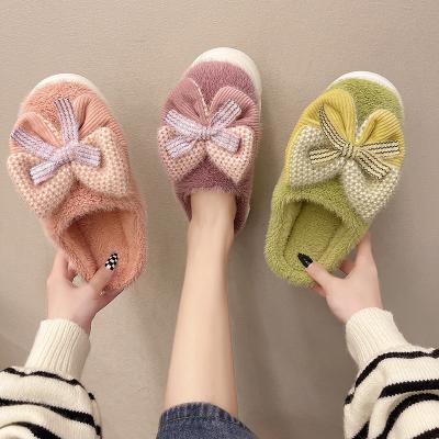 China Autumn and winter women's anti-skid warm slippers indoor and outdoor cute knot decorated plush slippers for sale