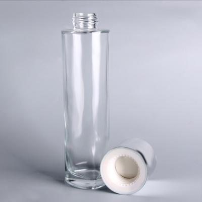 China Personal Care Wholesale Personal Care Custom Round Empty Glass Bottle Lotion Bottle With Silver Pump Lid For Cosmetic Packaging for sale