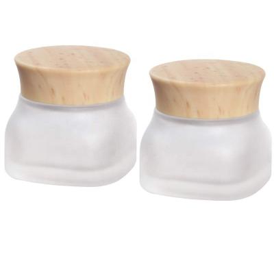 China Empty cosmetic luxury fancy square shape glass cream jar 50g 150g with bamboo lid for cosmetic for sale