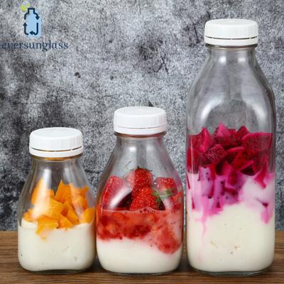 China 1L Square Long Glass Bottle Eco - Friendly With Safety Plastic Caps For Beverage Milk Juice for sale