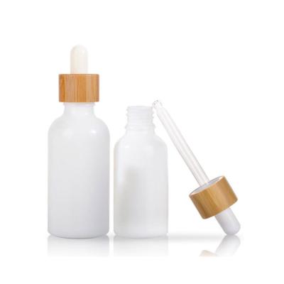 China Luxury White Glass Bottle 100ml 30ml 50ml Cosmetic Bamboo Wood Opal Porcelain Dropper Bottle Packaging for sale