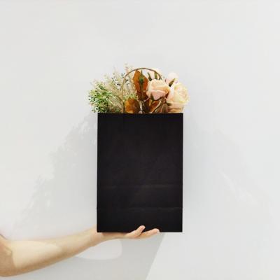 China Handmade Small Black Kraft Paper Bag Plain Handle Shopping Gift Bag Black Paper Bag for sale