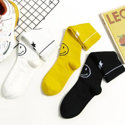 China Cute Girl Foot Smile Sweat-absorbent Stock Cotton Tube Socks For School for sale