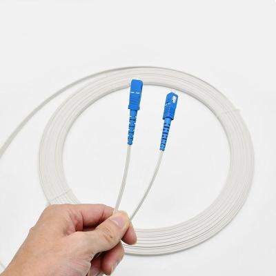 China Outdoor White FTTN 50m SC G657a Fiber Ftth Drop Patch Cable SC SM Mm Fiber Optic Patch Tie 1core 3 Wire Butterfly Optic Cord for sale