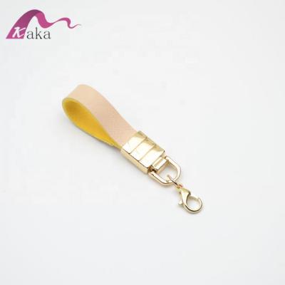 China 7cm eco-friendly material eco-friendly gold material kc pu leather key chain ornament for bag or key for sale