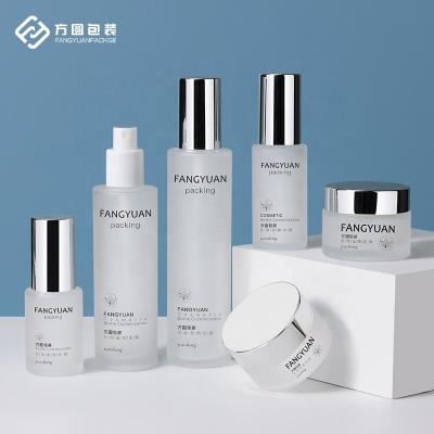 China In China Stock Factory Wholesale Silver Cap Frosted Cosmetic Glass Bottle Jars And Packaging Bottle Supplier for sale