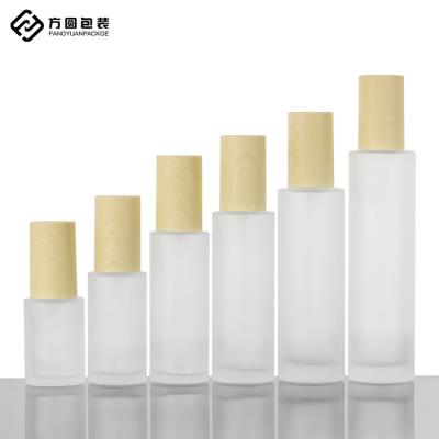 China In Stock Skin Care Packaging Factory Wholesale Cylinder Frosted Grain Lid Lotion Oil Pump Bottle Wood for sale