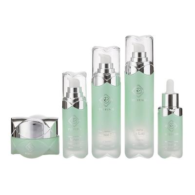 China Personal Lotus Hat Wholesale Personal Hat Luxury Glass Skin Care Empty Packaging Set With Lotion Pump Bottle Dropper Bottle OEM Logo for sale