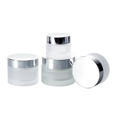 China Cosmetic Frosted Cosmetic Packaging Round Ointment Container Cream Glass Jar With UV Silver Lid for sale