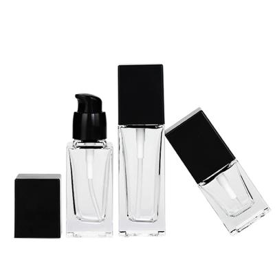 China In Square Stock Cosmetic Packaging Bottle Empty Luxury Base Glass Bottle Frosted Cosmetic Bottle With Pump for sale