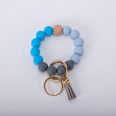 China DIANJIN Wooden Multi Colored Key Chain Key Ring Keyring With Tassel Silicone Bead Bracelet Bulk Bracelets for sale