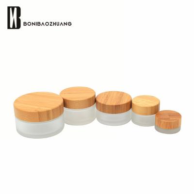 China Frost jar 15g 30g 50g 100g face eyecream cosmetic eco-friendly glass cream glass jar with real bamboo lid for sale