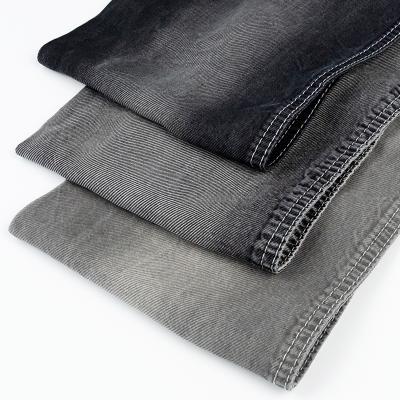 China Good New Design Breathable Jeans Fabric 7.1oz Black Tencel Raw Material 100% Twill Fabrics For Mens Jeans for sale