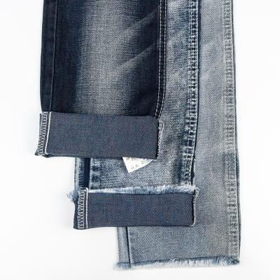 China Breathable Wholesale 72% Polyester 2% Cotton 26% Spandex 9.4oz Light Selvedge Trellis TR Blue Knit Denim Fabric for sale