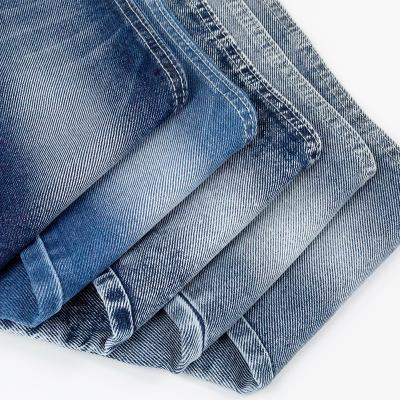 China Breathable Denim Fabric Wholesale Lightweight Twill Jeans Material 65% Cotton 33% Polyester 2% Spandex 8.3oz OE Selvage Knit Denim Dress Fabric for sale