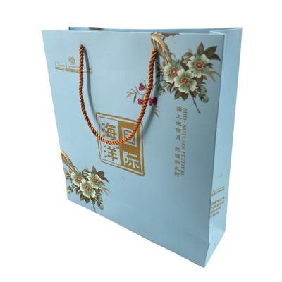 China Custom Luxury Biodegradable Hotel Gift Paper Packaging Bag With Handle Festival Business Shopping Kraft Paper Bag for sale