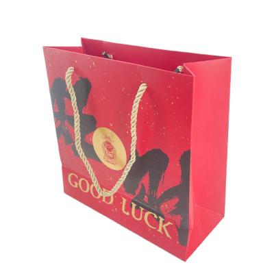 China Custom Fancy Biodegradable Blessing Gift Art Paper Packaging Bag With Ribbon Handle For Business Shopping Tote Bag for sale