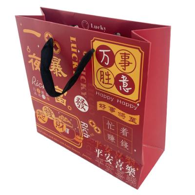 China Custom Biodegradable Blessing Gift Festival Art Paper Packaging Bag With Ribbon Handle For Business Shopping Fancy Packaging Bag for sale