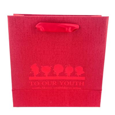 China Biodegradable Custom Luxury Gift Special Red Gift Paper Packaging Bag With Handle Business Shopping Kraft Paper Bag for sale