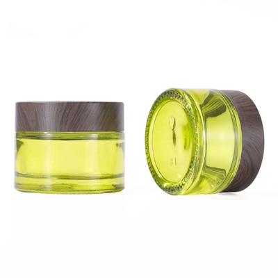 China 10g Mini Clear Green Frosted Cosmetics Storage Cream Glass Bottles And Jars With Plastic Wood Grain Lid for sale