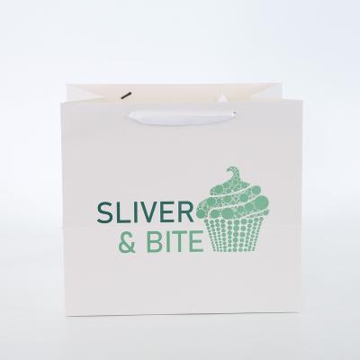 China Custom Recyclable White Logo Ribbon Handle Gift Luxury Apparel Boutique Shopping Paper Bag for sale