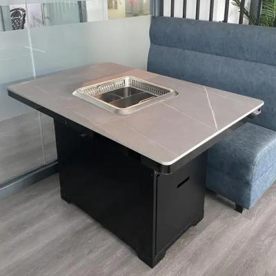 China Modern Commercial Hotel Hot Pot Table Stainless Steel Smokeless Hot Pot Dining Table for sale