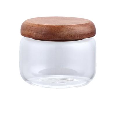 China Kitchen Heatable Glass Storage Jar Round Borosilicate Glass Jar With Acacia Wood Lid for sale