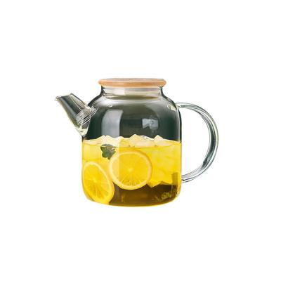 China Sustainable High Borosilicate Glass Flower Teapot Water Kettle With Wooden Lid For Home for sale