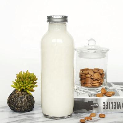 China Empty Beverage Almond Milk Glass Bottles 16oz With Screw Lid Around Glass Juice Bottles For Drinking for sale