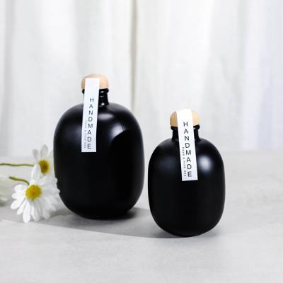 China Beverage 250ml 500ml Glass Ball Shape Round Black Bottle With Cork For Wine Packaging for sale