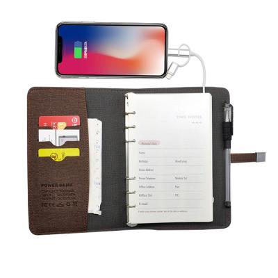 China Hard Cover Book China Factory 8000mah Planner Power Bank Wireless Charging Notebook with Phone Pocket and USB for sale