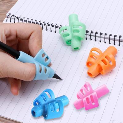 China FILL 2022 Kids Pencil Holder Writing Aid Grip Trainer Pen Grip Free Shipping Pencil Grips For Kids Pencil Case for sale