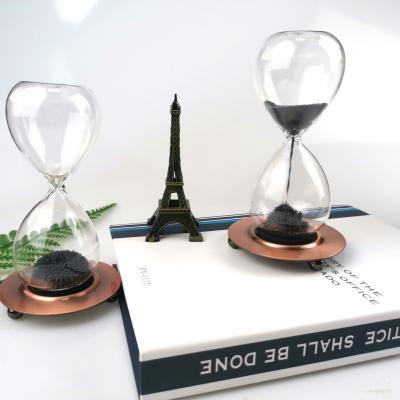 China Contemporary creative magnetic colck desktop decoration for Christmas gifts galss hourglass sand timer for sale