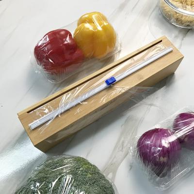 China / Wholesale Vegetable Kitchen Cutter Tool Fruit Plastic Cling Film Cutter Cling Wrap Film Dispenser With Slide Cutter for sale