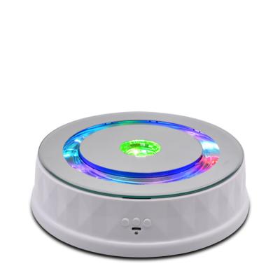 China 360 Degree Rotating Luxury Colorful 360 Lights Rotating Display Stand for sale