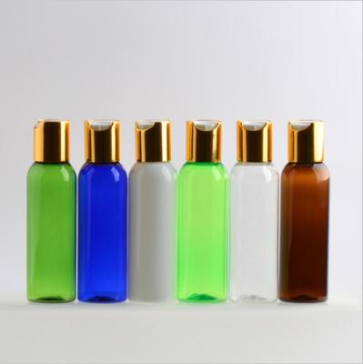 China Household Products 60ml PET Round Shape Plastic Cosmetic Shampoo Bottle With Gold And Silver Press Cap for sale