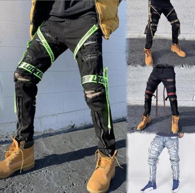 China 2021 QUICK DRY - 067 In Street Fashion Hip Hop Running Jeans Pants With Ribbons Letter Print Ripped Pencil Jeans Men Slim Fit for sale