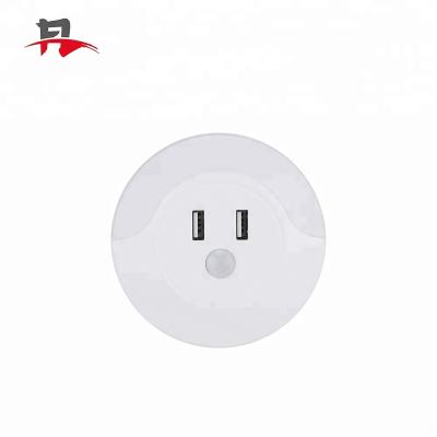 China Modern Light Sensor Led Plug Night Light With Dual USB Charger Wall Lamp EU US Plug Kids White Night Light for sale