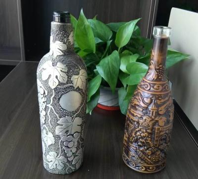 China 3D glass wine bottle carving viewing, special embossing bottle for premium wine, glass bottle for sale