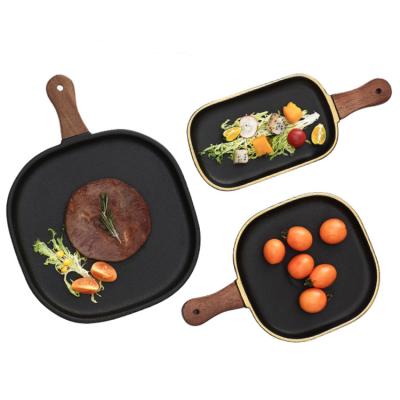 China Sustainable Ceramic Wooden Handle Baking Tray Desserts Swing Racket Plate Household Steak Pasta Dish Western Bake Handle Tableware for sale