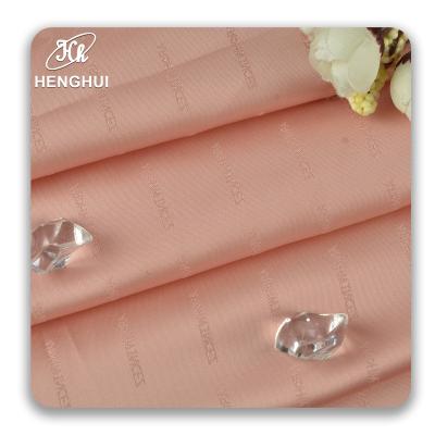 China Luxury QUICK DRY shinny satin fabric textiles for clothes dress suit 100% acetate 120GSM letter jacquard brocade fabric for sale