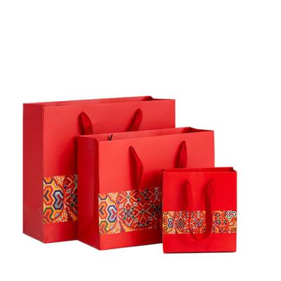 China Manufacturer Eco Friendly Custom Logo Printed Red Cardboard Luxury Exquisite Gift Paper Bag for sale