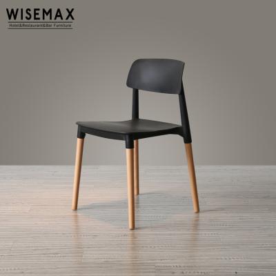 China Modern Wholesale High Quality PP Seat Plastic Chairs Stacking Leisure Dining Chairs With Solid Wood Legs for sale