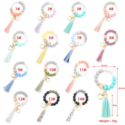 China Silicon Customized Amazon TOP Selling Colorful PU Monogram Tassel Leather Key Ring Women Girls Wood Silicone Beads Bracelet Key Chain for sale