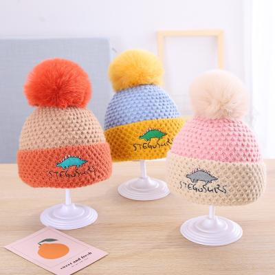 China Fur COMMON Dinosaur Winter Woolen Hats For Boys And Girls Cartoon Knitted Newborn Wool Wholesale Bunny Hat Baby Pompom Hat Manufacturer for sale