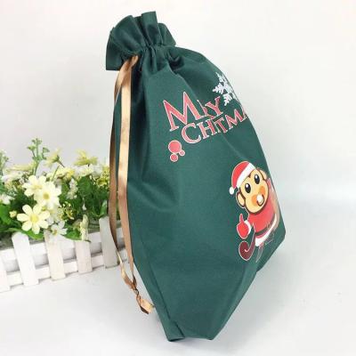 China 100% New Arrival Merry Christmas Gift Candy PP Ribbon Non Woven Silk Pouch Bag Eco-friendly and Biodegradable Santa Bags for sale